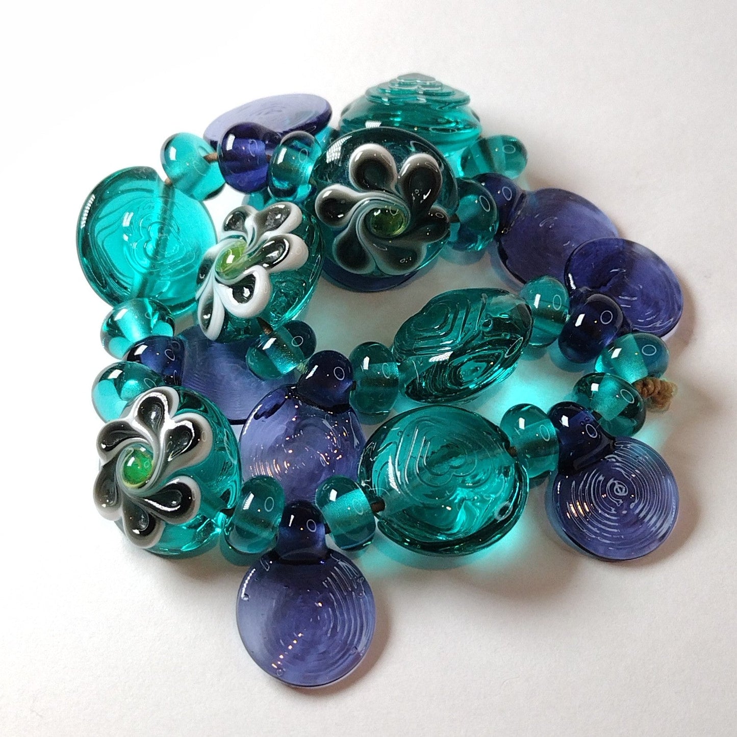 Large set of teal and purple daisy themed lampwork beads Jolene Beads