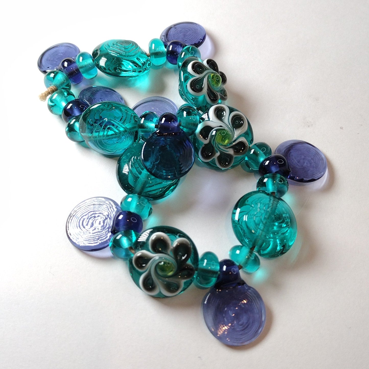 Large set of teal and purple daisy themed lampwork beads Jolene Beads