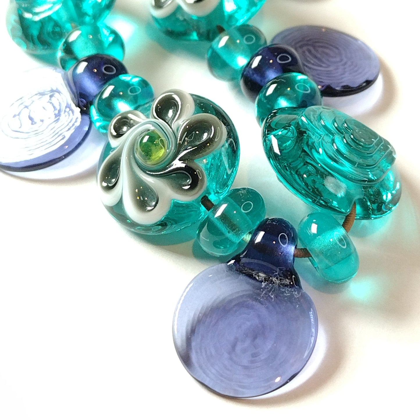 Large set of teal and purple daisy themed lampwork beads Jolene Beads