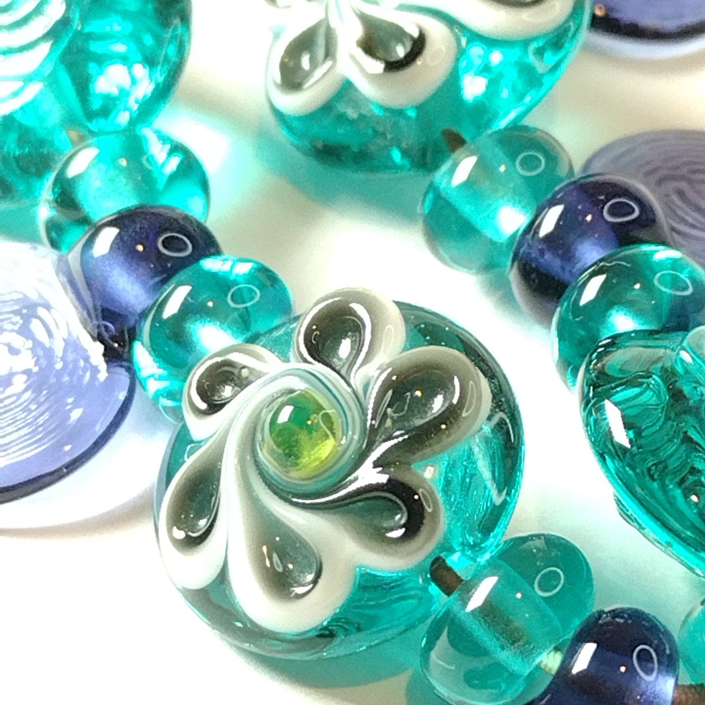 Large set of teal and purple daisy themed lampwork beads Jolene Beads