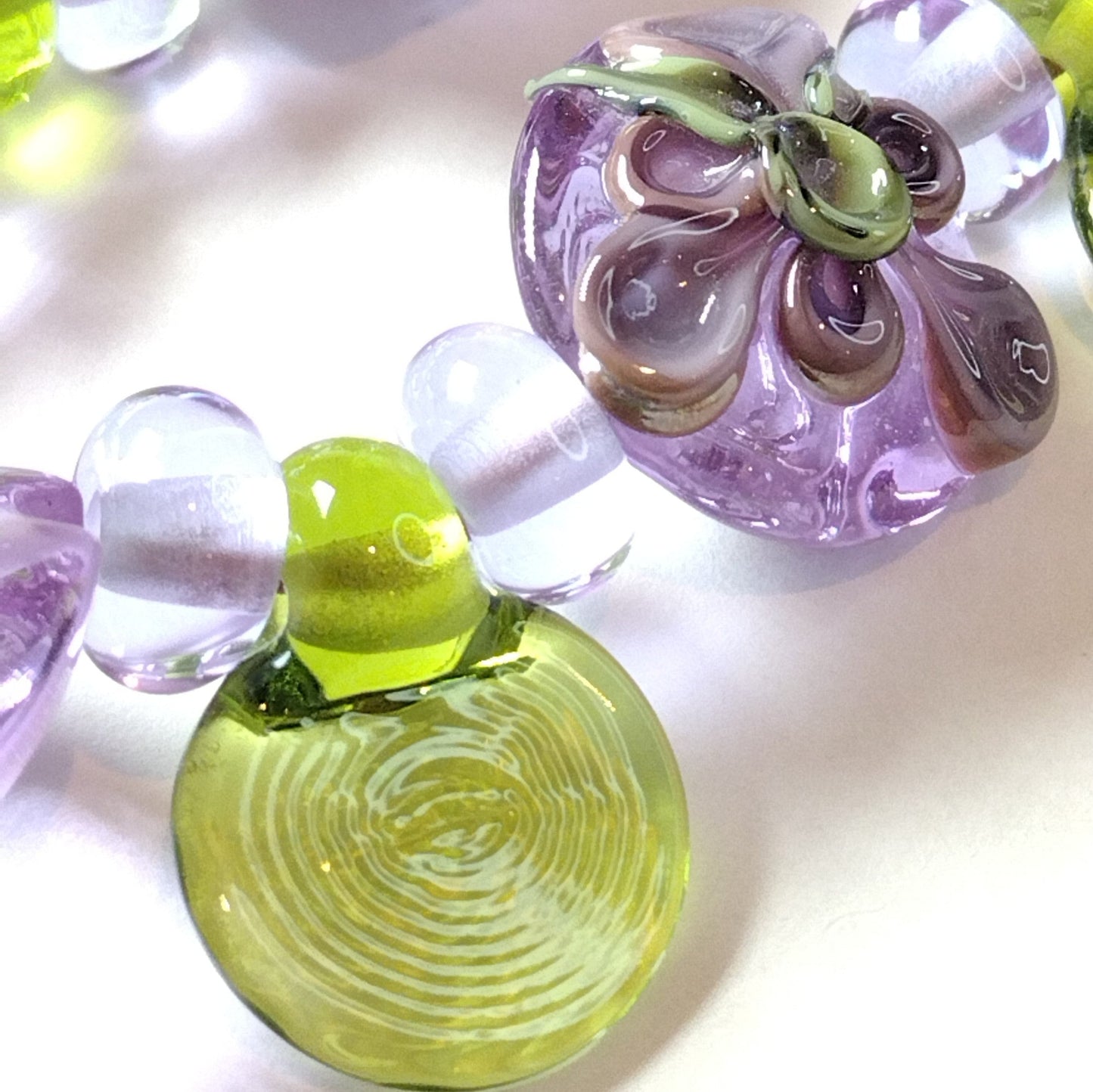 Large set of lilac flower and heart themed lampwork beads Jolene Beads
