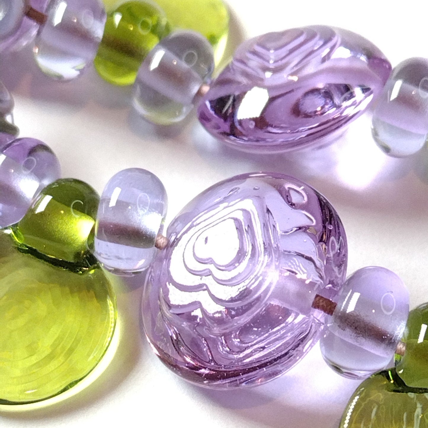 Large set of lilac flower and heart themed lampwork beads Jolene Beads