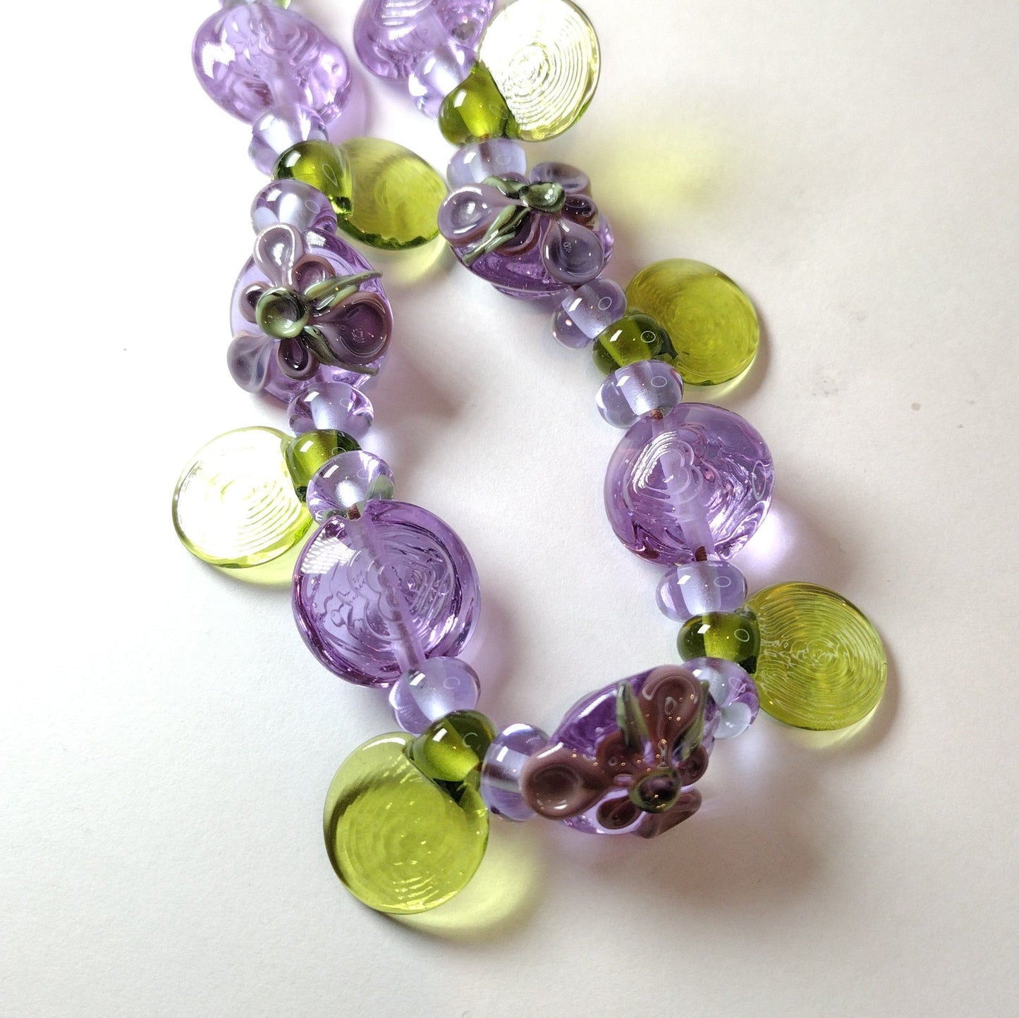 Large set of lilac flower and heart themed lampwork beads Jolene Beads