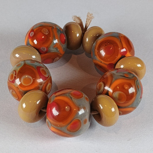 handmade glass beads in orange and brown  