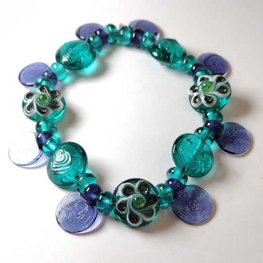 Large set of teal and purple daisy themed lampwork beads Jolene Beads