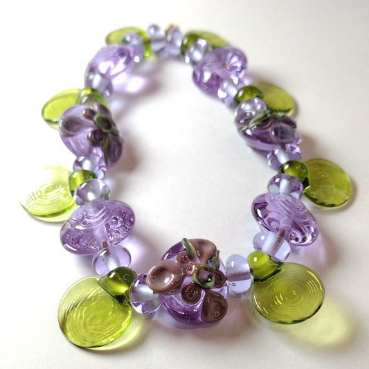 Large set of lilac flower and heart themed lampwork beads Jolene Beads