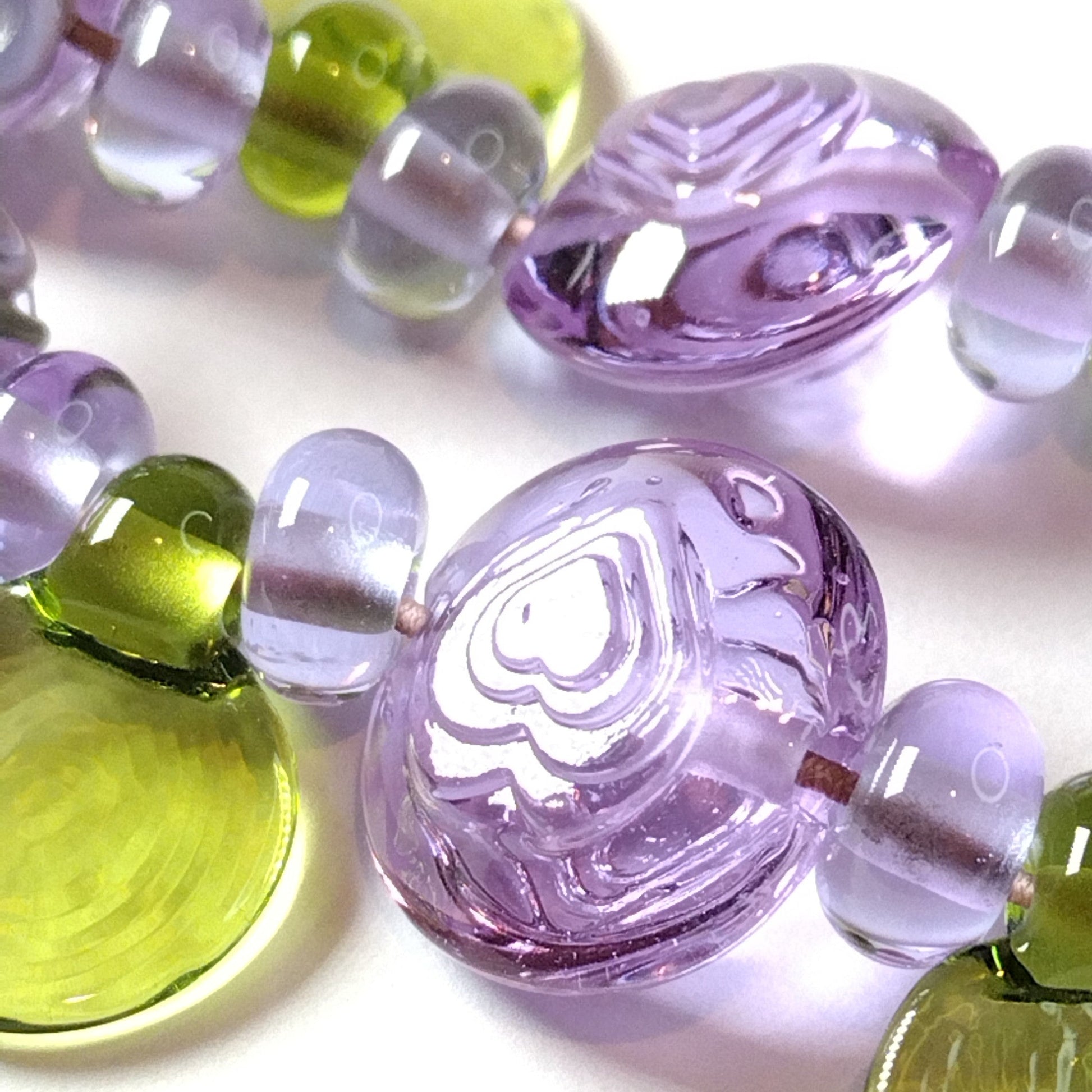Large set of lilac flower and heart themed lampwork beads Jolene Beads