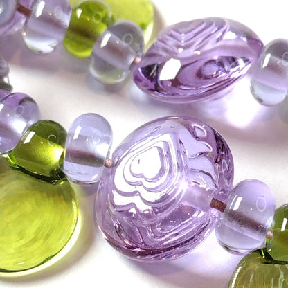 Large set of lilac flower and heart themed lampwork beads Jolene Beads