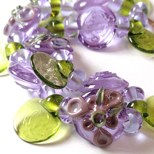 Large set of lilac flower and heart themed lampwork beads Jolene Beads