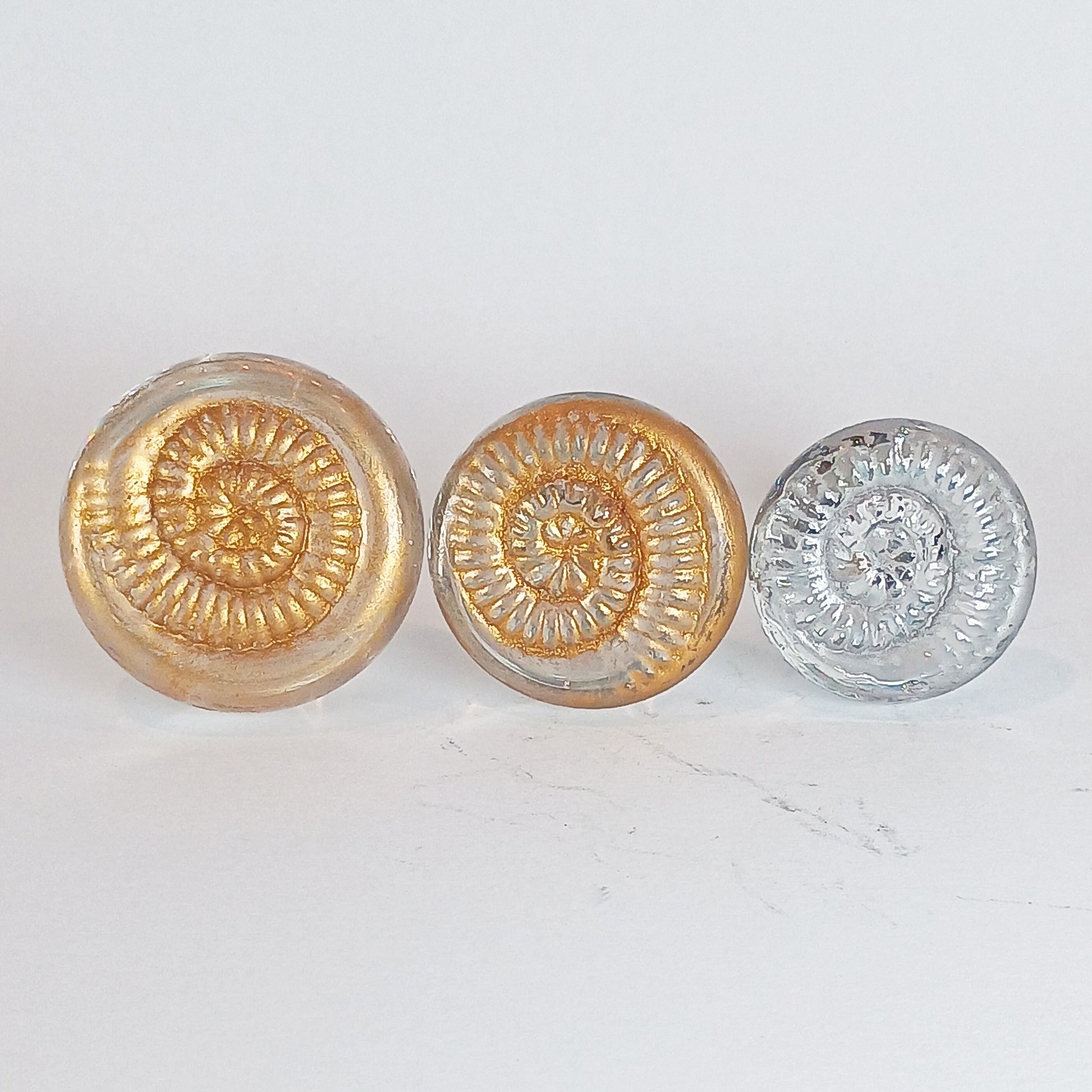 Clear glass ammonite texture drawer knobs with gold or silver detail 