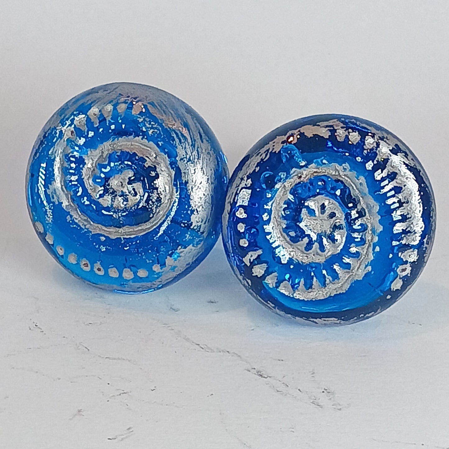 Handmade aqua blue glass ammonite glass knobs with a silver antique silver wax finish 