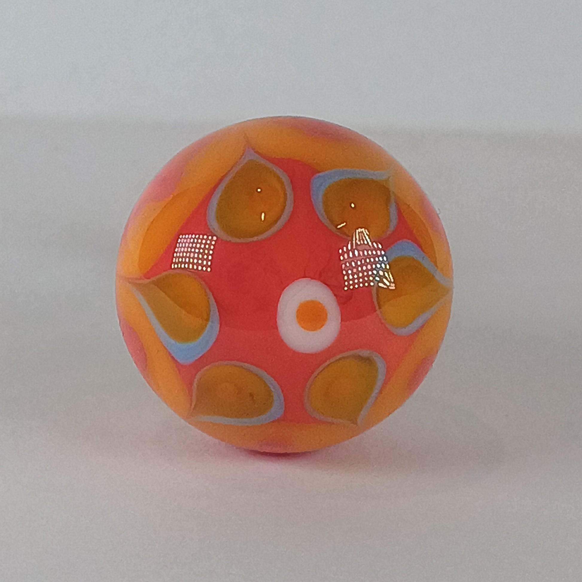 Decorative glass draw knob with orange and blue patterns