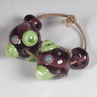 Purple and green bumpy lampwork bead pair Jolene Beads